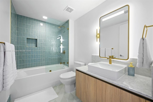 full bathroom with tile patterned floors, toilet, tiled shower / bath, and vanity