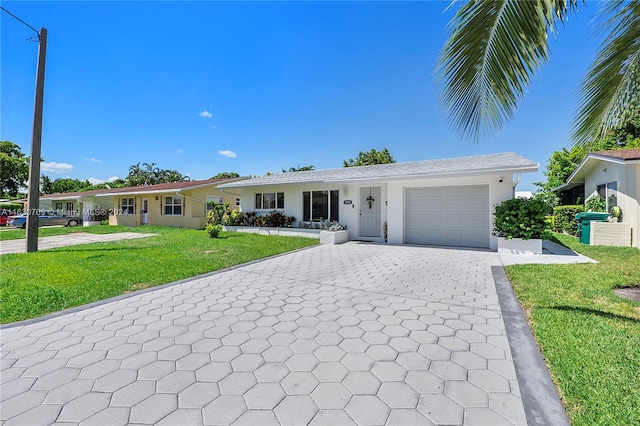 ranch-style house with a garage and a front lawn