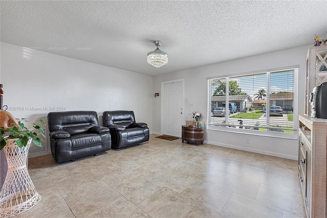 living room featuring light tile patterned floors and a textured ceiling