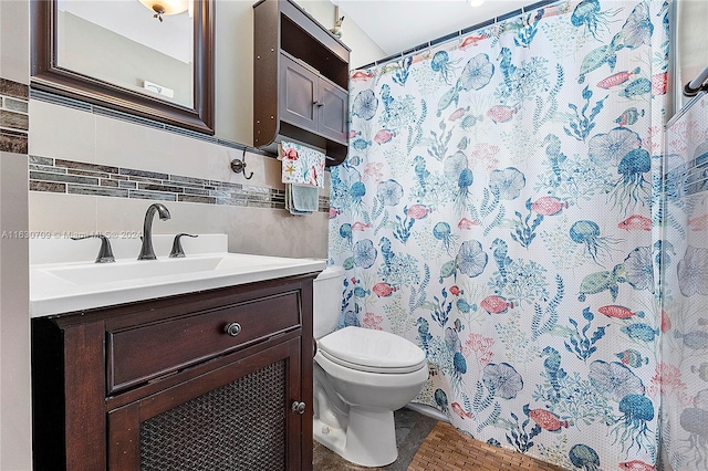 bathroom featuring decorative backsplash, vanity, a shower with curtain, and toilet