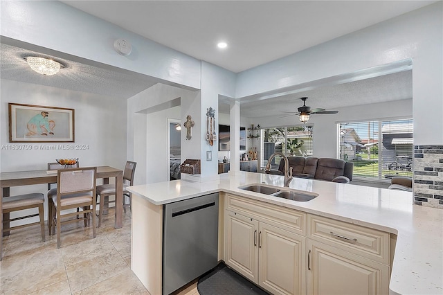 kitchen featuring ceiling fan, dishwasher, light tile patterned floors, sink, and a textured ceiling