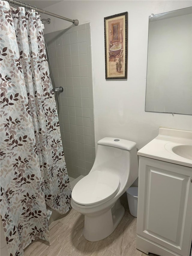 bathroom with a shower with shower curtain, toilet, and vanity