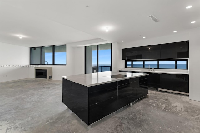 kitchen with a water view and a center island