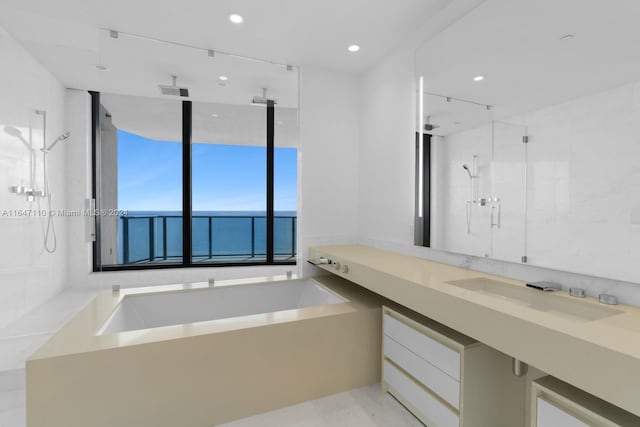 bathroom featuring a sink, a garden tub, recessed lighting, and walk in shower