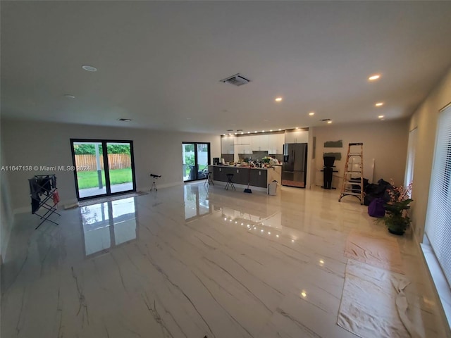 unfurnished living room featuring recessed lighting, marble finish floor, and visible vents