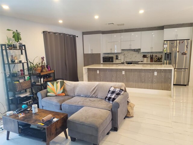 living room with sink and light wood-type flooring