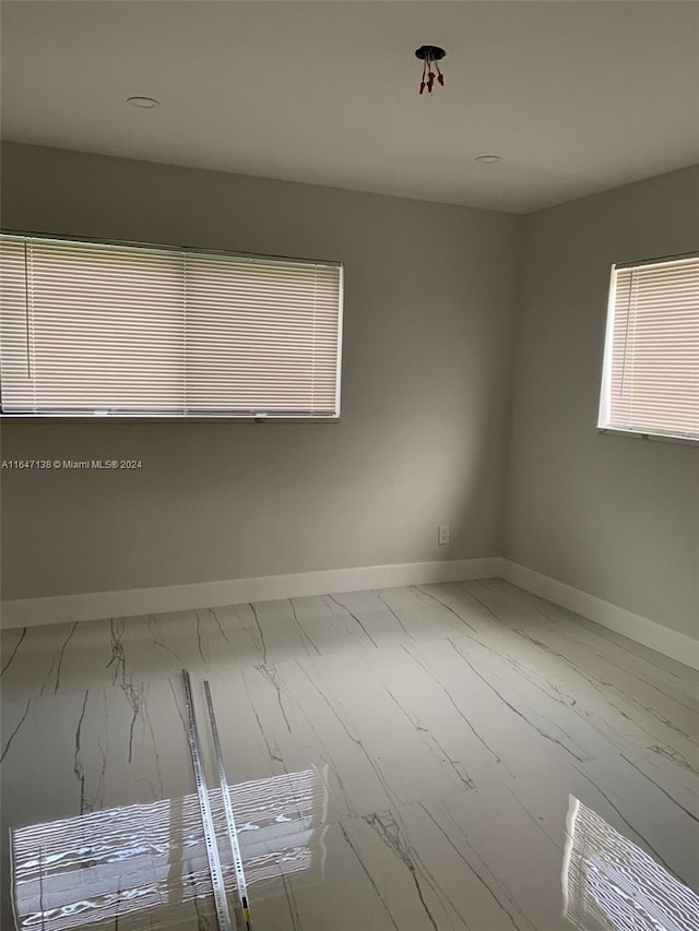 empty room with hardwood / wood-style flooring