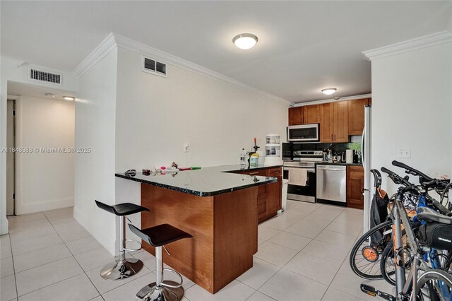 interior space with light tile patterned flooring, crown molding, and a healthy amount of sunlight