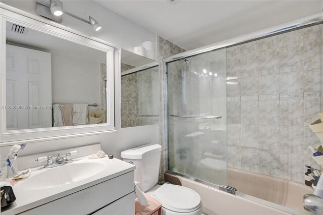 bedroom featuring light tile patterned floors, ornamental molding, and a closet