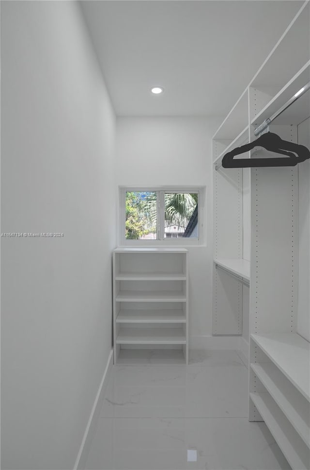 spacious closet featuring marble finish floor