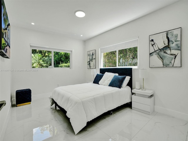 bedroom with marble finish floor, recessed lighting, and baseboards