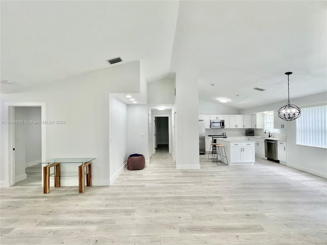 unfurnished living room featuring a chandelier, sink, light hardwood / wood-style flooring, and vaulted ceiling