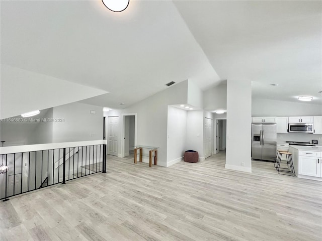 living room with lofted ceiling and light hardwood / wood-style flooring