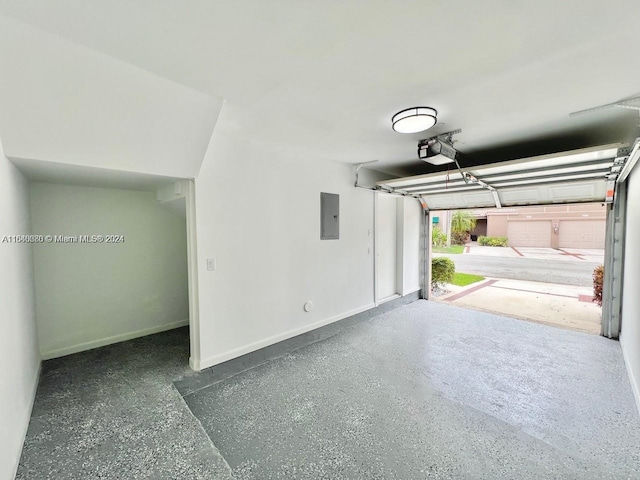 garage with electric panel and a garage door opener