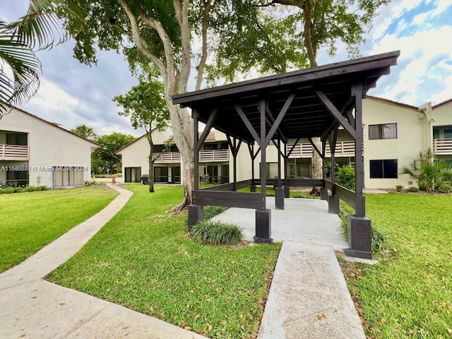 view of property's community with a lawn and a gazebo