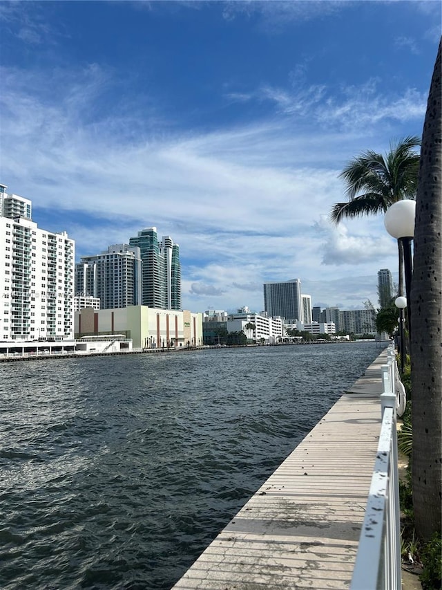 view of dock featuring a view of city and a water view