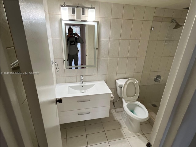 full bathroom with tile patterned flooring, toilet, a stall shower, and vanity