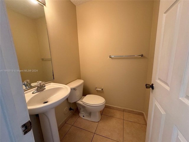 bathroom with tile patterned flooring and toilet