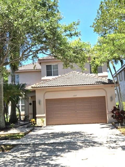 mediterranean / spanish home with a garage