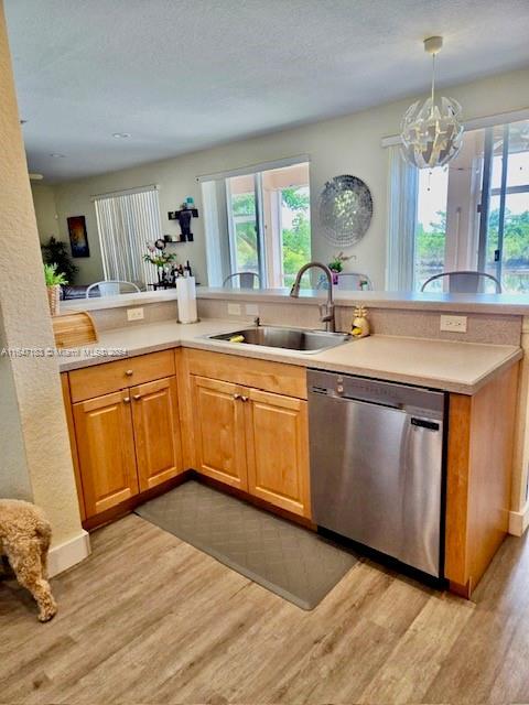 kitchen featuring appliances with stainless steel finishes, a textured ceiling, light hardwood / wood-style floors, and light brown cabinets