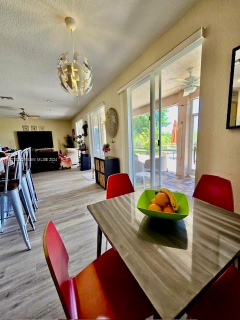 kitchen with light brown cabinetry, appliances with stainless steel finishes, and light hardwood / wood-style floors