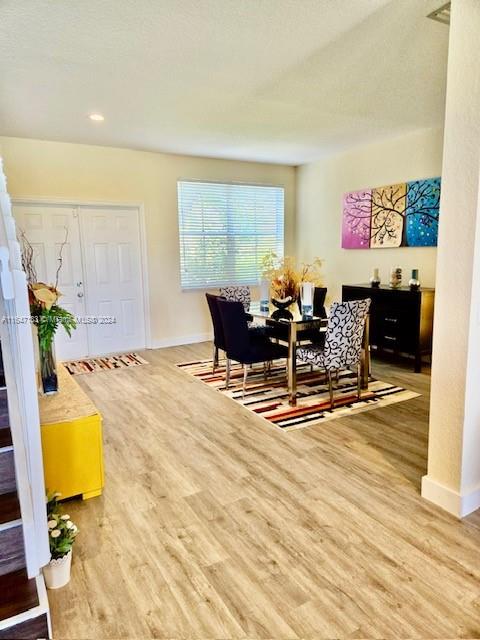 living room featuring hardwood / wood-style floors and a textured ceiling