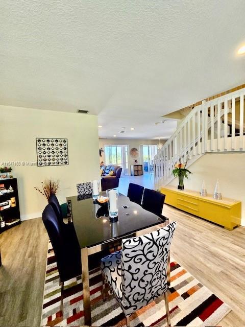 living room featuring hardwood / wood-style floors and a textured ceiling