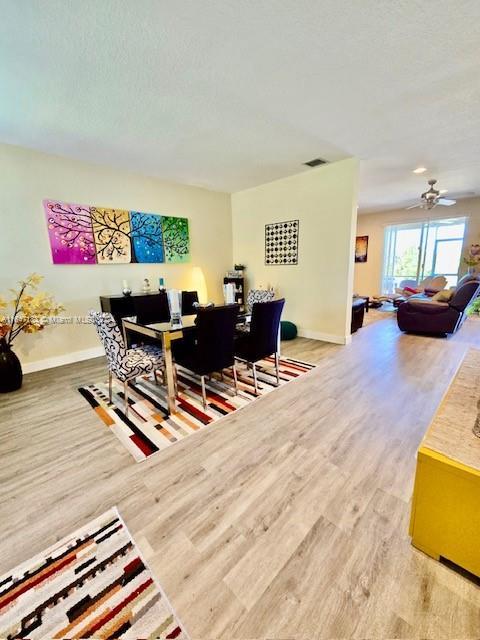 living room with hardwood / wood-style flooring and ceiling fan