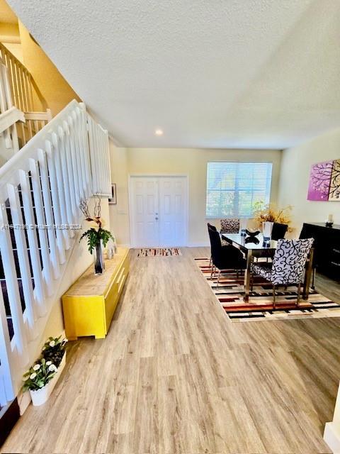 interior space featuring light hardwood / wood-style floors and a textured ceiling