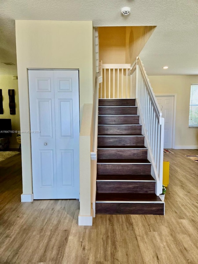 interior space with light hardwood / wood-style floors and stacked washer and dryer