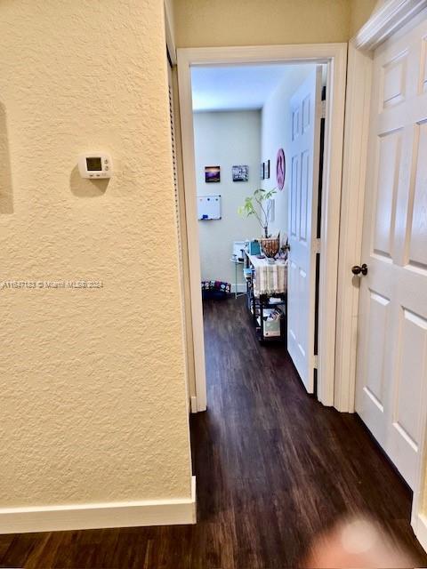 corridor with dark hardwood / wood-style floors