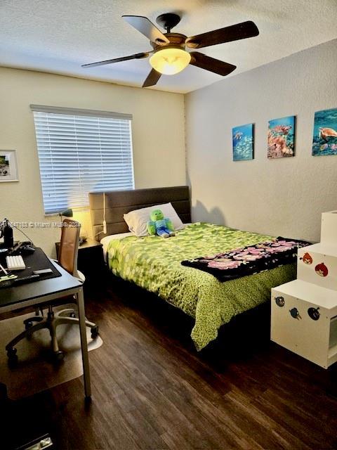 bedroom with a closet and dark hardwood / wood-style flooring