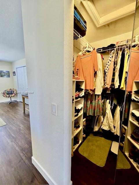 bedroom featuring a closet, a textured ceiling, and dark hardwood / wood-style flooring