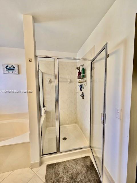 bathroom with vanity, independent shower and bath, and tile patterned flooring