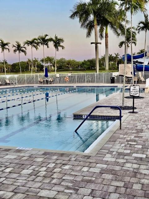 pool at dusk with a patio