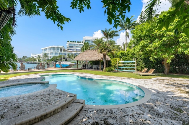 view of pool with an in ground hot tub