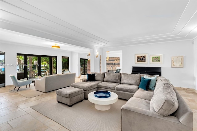 tiled living room featuring crown molding and french doors