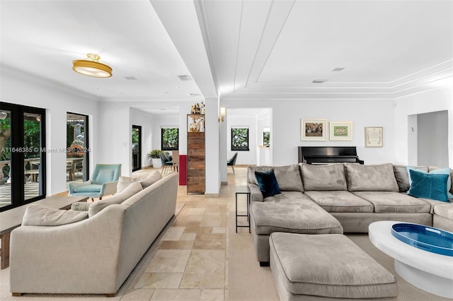 living room featuring a tray ceiling, light tile patterned flooring, and french doors