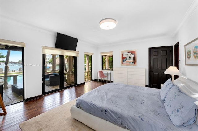 bedroom with crown molding, access to exterior, and hardwood / wood-style floors