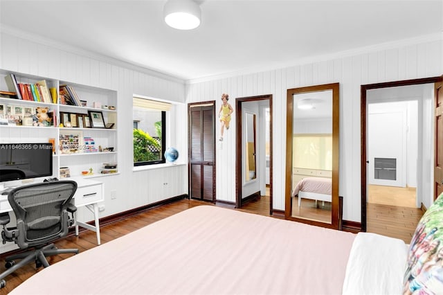 bedroom featuring dark wood-type flooring and ornamental molding