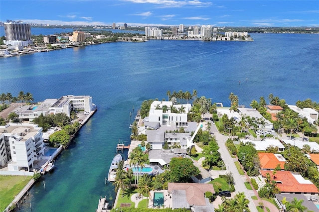 birds eye view of property with a water view and a view of city