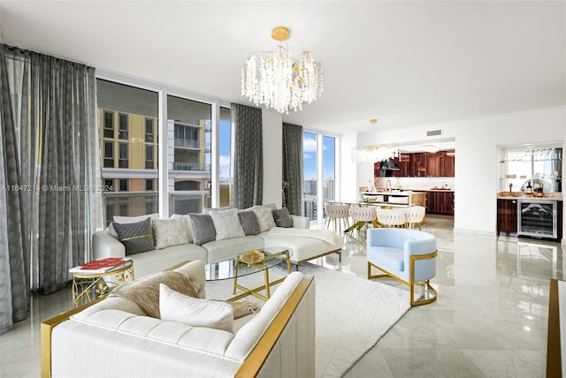 living room with a chandelier, wine cooler, and plenty of natural light