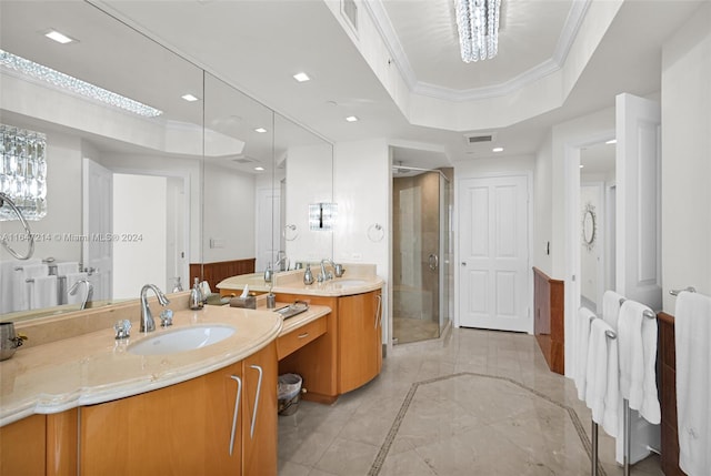 bathroom featuring vanity, a tray ceiling, ornamental molding, a chandelier, and a shower with door