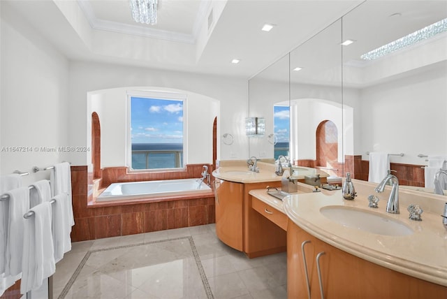 bathroom featuring crown molding, a relaxing tiled tub, vanity, and plenty of natural light