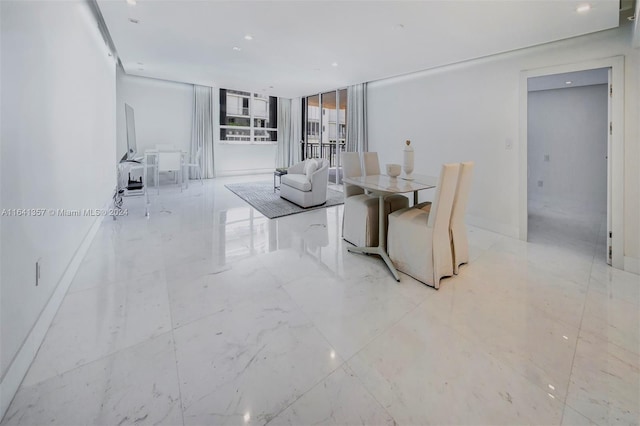 dining area featuring floor to ceiling windows and light tile patterned floors