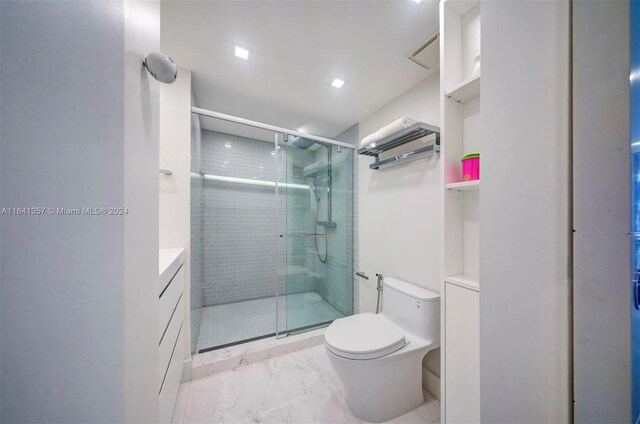 bathroom with tile patterned flooring, an enclosed shower, vanity, and toilet