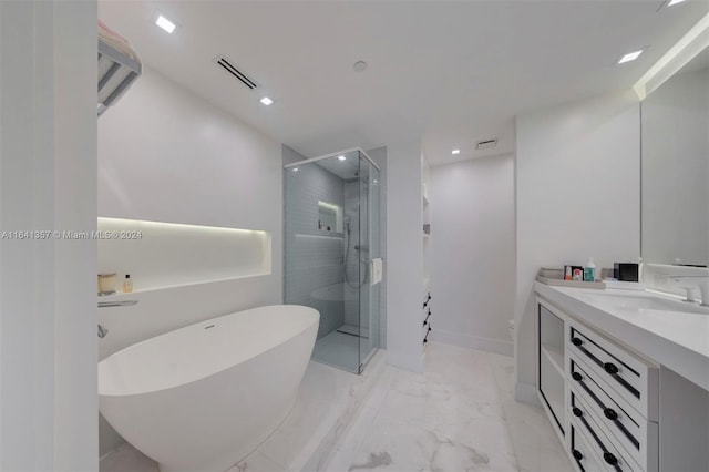 bathroom featuring tile patterned flooring, independent shower and bath, and vanity