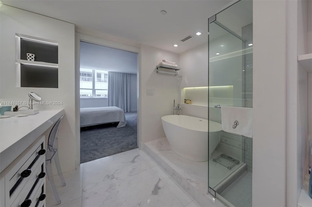 bathroom with tile patterned floors, vanity, and shower with separate bathtub