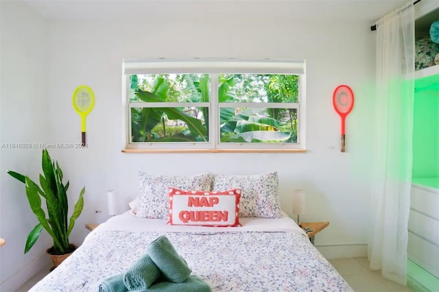 tiled bedroom featuring multiple windows