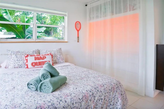 bedroom with light tile patterned floors